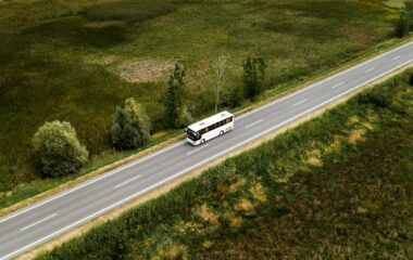Aerial view of passenger bus on road through countryside